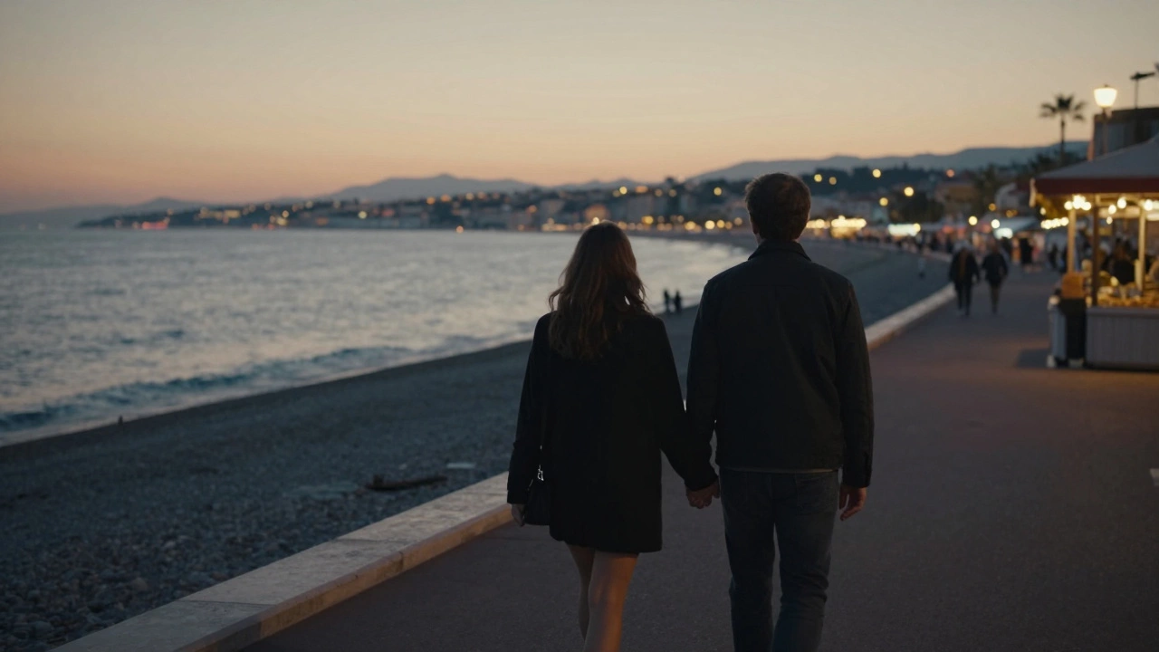 A woman and companion walking peacefully along the Nice seaside at sunset.